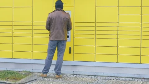 Receiving a parcel out of the parcel station Video stock 97406453