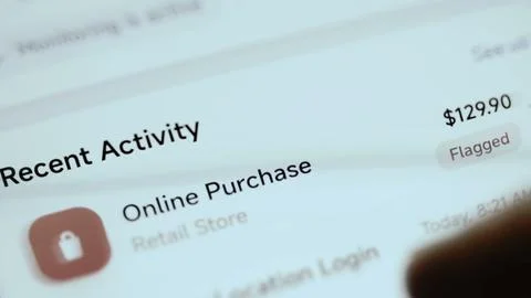 Recent activity screen flags a 129.90 USD online purchase at a retail Stock Photos