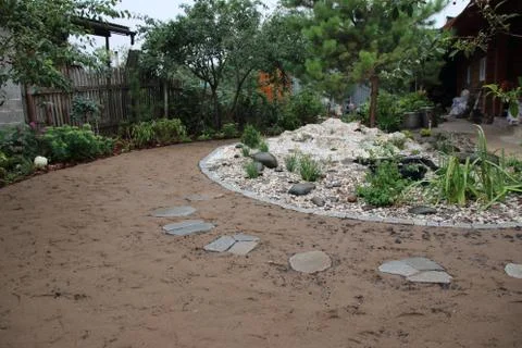 Recently created landscape garden with an installed preformed plastic pond Stock Photos