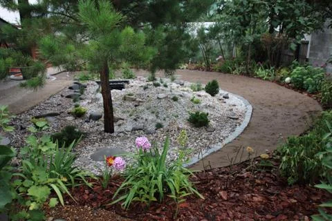 Recently created landscape garden with an installed preformed plastic pond Stock-Fotos