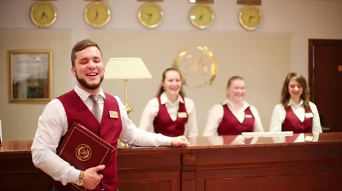 Receptionist with folder at counter for guests in hotel Stock Footage 40065951