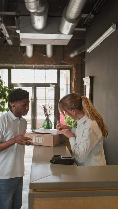 Receptionist Getting Parcel while Working in Business Center Stockbeeldmateriaal 316595344