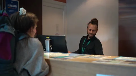 Receptionist giving key card Stock Footage 142994964
