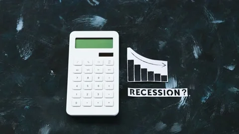 Recession text next to calculator with graphs showing stats going down Stock Footage 196204622