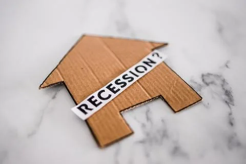 Recession text with question mark over house icon made of cardboard, post pan Stock Photos