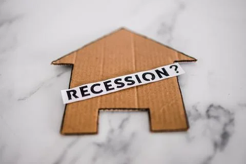Recession text with question mark over house icon made of cardboard, post pan Stock Photos