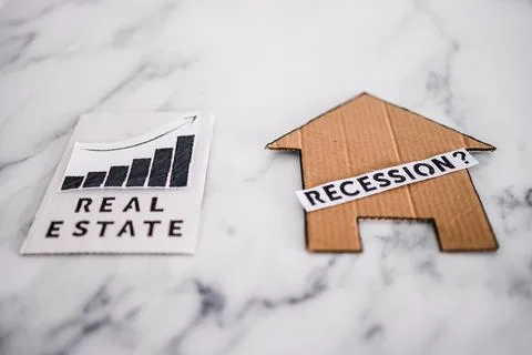 Recession text with question mark over house icon made of cardboard next to r 스톡 사진