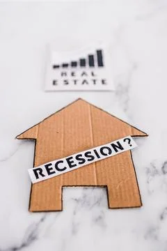 Recession text with question mark over house icon made of cardboard next to r 스톡 사진