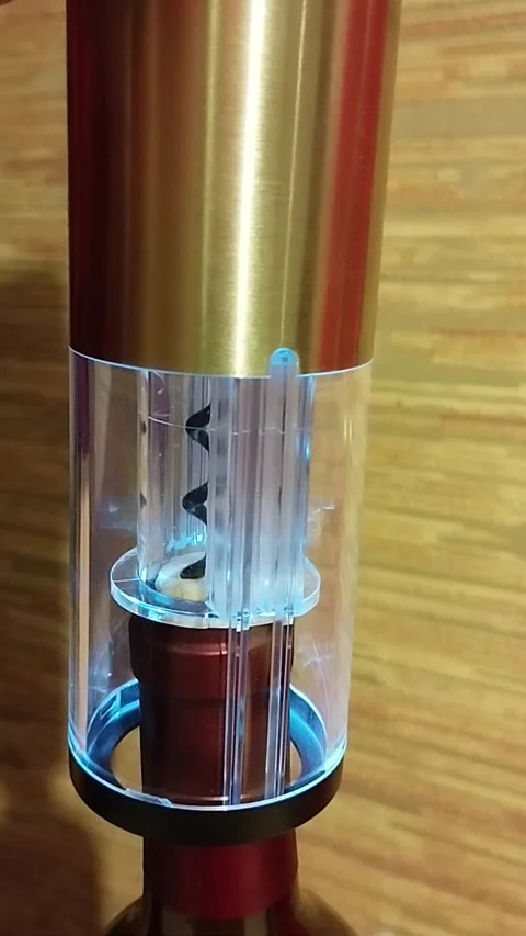Rechargeable electric corkscrew that opens a bottle of wine and pulls Stock Footage 219741790