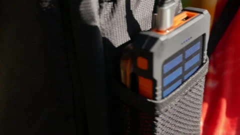 A rechargeable mobile power pack with solar panels in female traveler's backpack Stock Footage 160084634