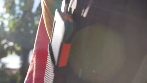 A rechargeable mobile power pack with solar panels in female traveler's backpack Stock Footage 160085064