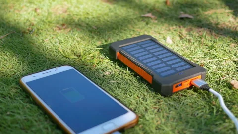 Rechargeable mobile power pack with solar panels on the lawn.  Stock Footage 160085159