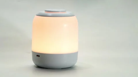 Rechargeable touch control bedside multi functional night light. Stock Footage 317702078