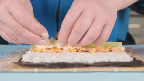 Recipe for making sushi rolls in the kitchen at home Stock Footage 131887283