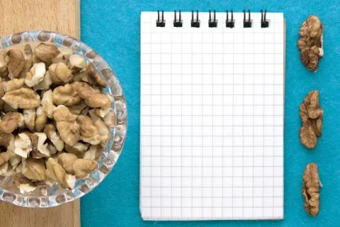 Recipe notebook with walnuts on a blue background Stock Photos