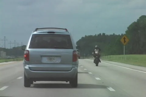 Reckless Driving - Biker Does Wheelie On The Interstate Stock Footage