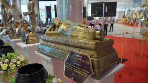 Reclining Small Lying Buddha Statue, Thai Asian Students Praying In Background Stock Footage 249975109