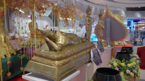 Reclining Small Lying Buddha Statues Figures, Buddhist Festival In Shopping Mall Stock Footage 249974941