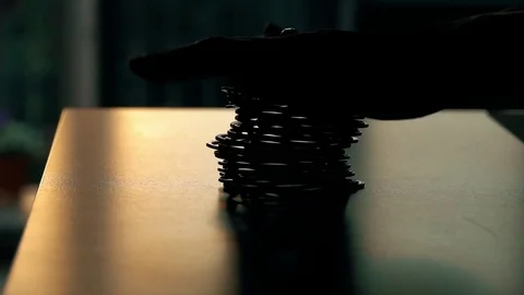 Recoiling toy spring on the table, slow motion video. Energy conservation Stock Footage 76038130