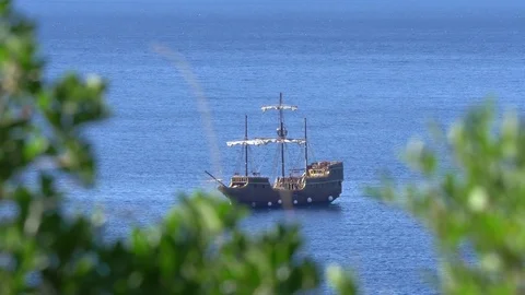 Reconstructed old sailing ship seen throug tree leaves Stock Footage 71177637