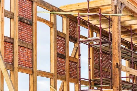 Reconstruction of an old building with a skeleton (half-timbered) structure. Stock Photos