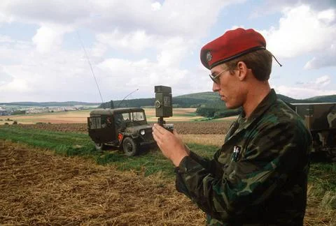 RECORD DATE NOT STATED An Army infantryman takes a compass reading in the ... Stock Photos