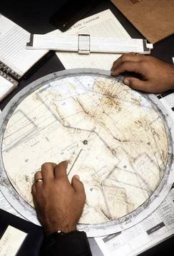 RECORD DATE NOT STATED An azimuth plotting board and a slide rule are used... 스톡 사진