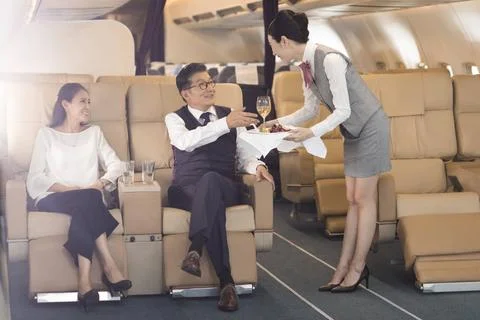 RECORD DATE NOT STATED Chinese airline stewardess serving food to passenge... Stock Photos