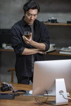 RECORD DATE NOT STATED Chinese photographer using computer in studio Beiji... Stock Photos