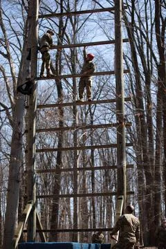 RECORD DATE NOT STATED A competitor scales a high obstacle during the obst... Stock Photos