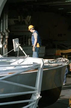 RECORD DATE NOT STATED A crewman checks over a pair of utility boats in th... Fotos Stock