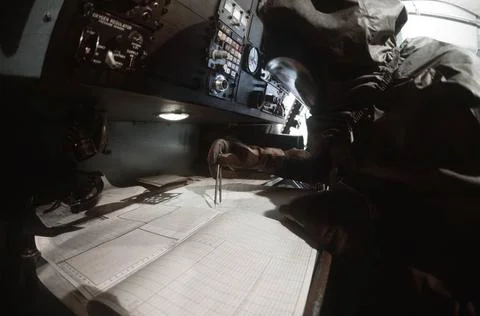 RECORD DATE NOT STATED A flight crewman in protective clothing plots a cou... Foto stock