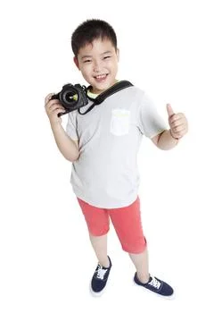 RECORD DATE NOT STATED Happy Chinese boy with SLR camera doing thumbs up B... Fotos Stock