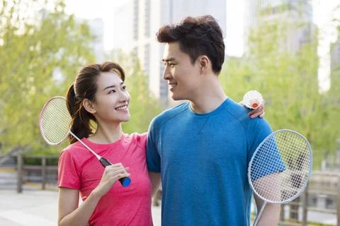 RECORD DATE NOT STATED Happy young Chinese couple playing badminton in par... Stock Photos
