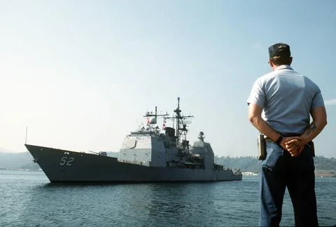 RECORD DATE NOT STATED A harbor master stands at parade rest on the pier a... Stock Photos