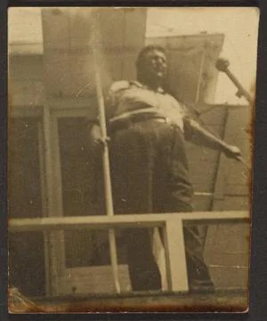 RECORD DATE NOT STATED  Man Above on Porch. Louis Fleckenstein, photograph... Fotos Stock