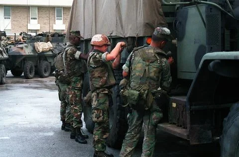 RECORD DATE NOT STATED Marines secure a canvas cover on a 5-ton truck in p... Stock Photos