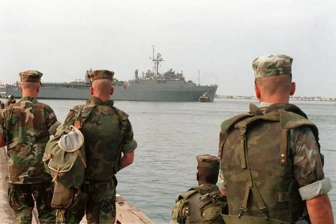 RECORD DATE NOT STATED Marines watch from a pier as the dock landing ship ... Stock Photos