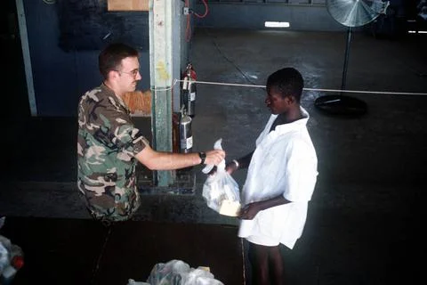 RECORD DATE NOT STATED A member of the U.S. Army hands out basic needs pac... Foto stock