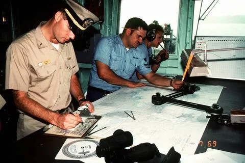 RECORD DATE NOT STATED A navigation team plots the ship s course aboard th... Fotos de archivo