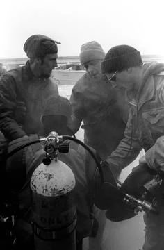 RECORD DATE NOT STATED A Navy diver is assisted at the completion of his d... Stock Photos