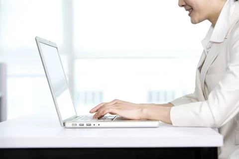RECORD DATE NOT STATED Office worker using her computer Beijing China Copy... Stock Photos