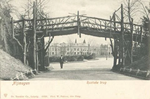 RECORD DATE NOT STATED Park with rustic wooden bridge. In the background h... Fotos Stock