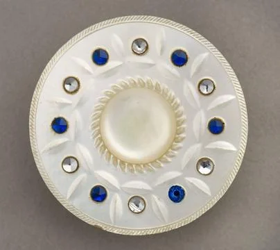 RECORD DATE NOT STATED  Pearl button with blue and mirror glass stones, 17... Stock Photos