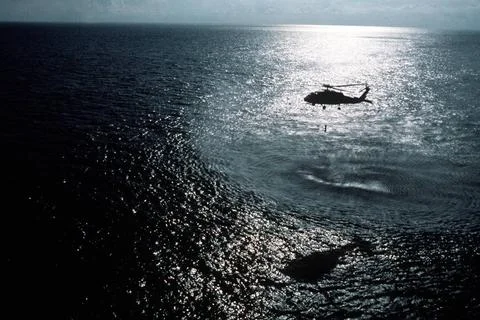 RECORD DATE NOT STATED An SH-60F Seahawk helicopter lowers a dipping sonar... Stock Photos