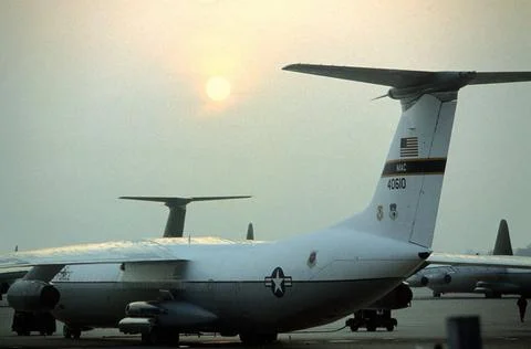 RECORD DATE NOT STATED The sun rises over a C-141B Starlifter aircraft par... Stock Photos