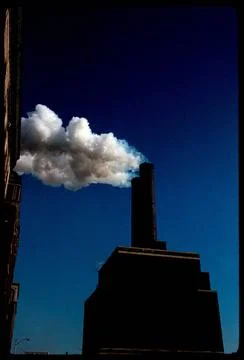 RECORD DATE NOT STATED Top of building with chimney stack emitting smoke ,... 스톡 사진
