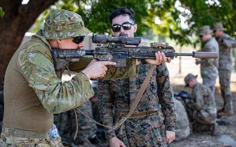 RECORD DATE NOT STATED  A U.S. Marine shows a Australian Soldier his M27 I... Stock Photos