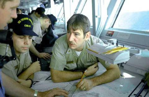 RECORD DATE NOT STATED A watch team plots the ship s position on the bridg... Fotos de archivo