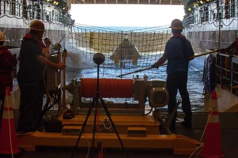 RECORD DATE NOT STATED  Winch team operators help guide a test version of ... Stock Photos
